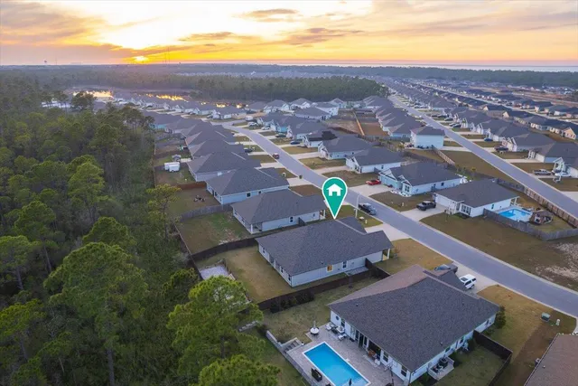 an aerial view of residential houses with outdoor space