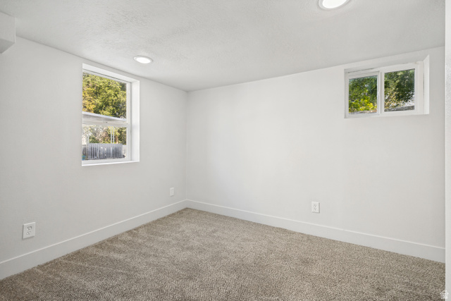 662 29th Street Ogden, UT 84403 - Photo 15 of 23 Bright room featuring two windows, neutral carpeting, recessed lighting, and white baseboards