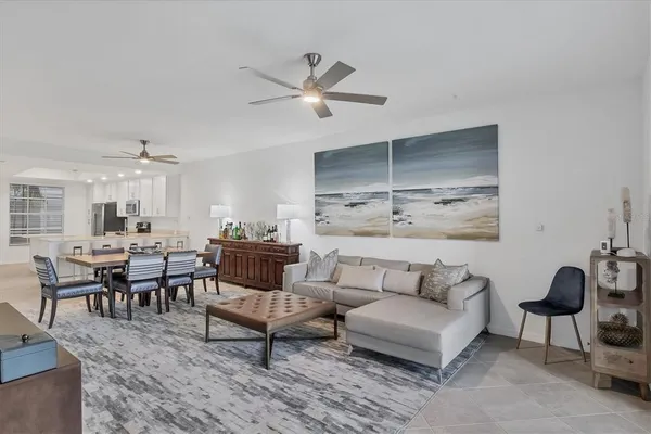 a bedroom with a bed a flat screen tv and a window