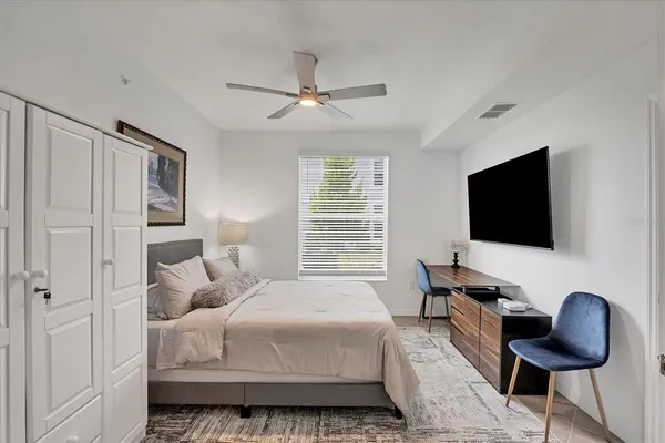 a bedroom with a bed and a chandelier