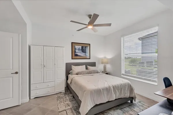 a bedroom with a bed and a painting on the wall