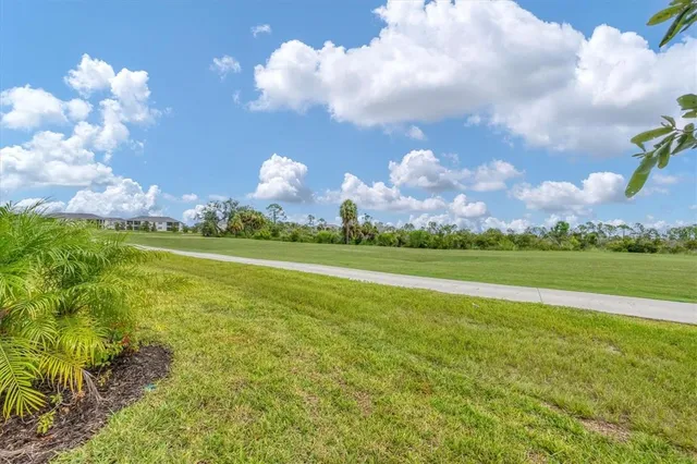 a front view of a house with a yard and street view