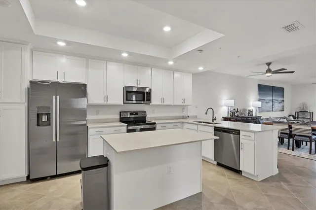 a kitchen with a sink a stove and cabinets