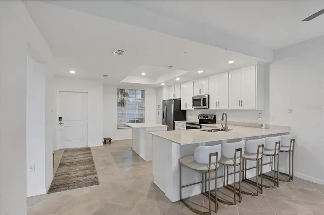 a dining room with furniture a rug and a painting