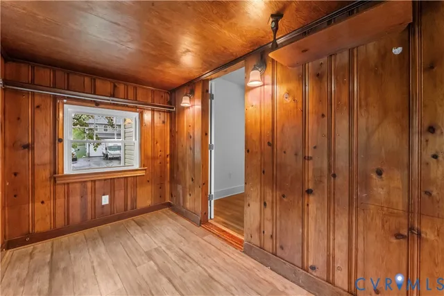 a view of hallway with a large window and wooden floor