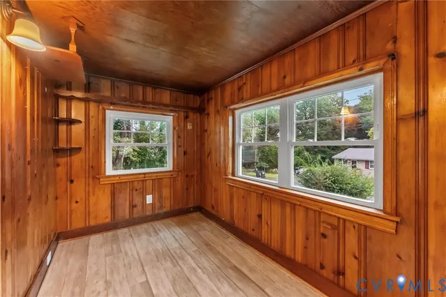 a view of a room with wooden floor and windows