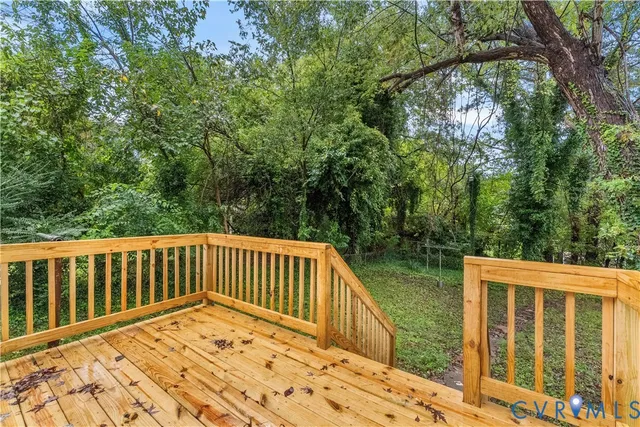 a view of balcony with wooden floor and fence