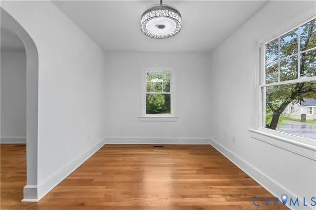 a view of a room with wooden floor and windows