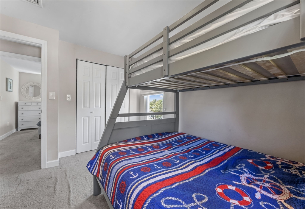 17 5th Street Wareham, MA 02558 - Photo 26 of 32 a bedroom with a bed and a chandelier