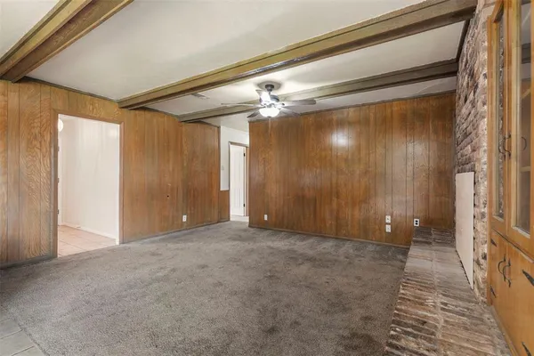 a view of a hallway with wooden shelves