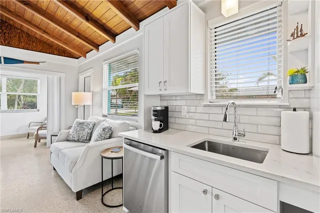 a kitchen with white cabinets and white appliances