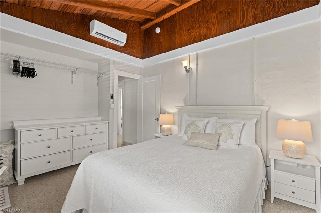 2134 Palm Street Naples, FL 34112 - Photo 14 of 36 a bedroom with a bed and a dresser