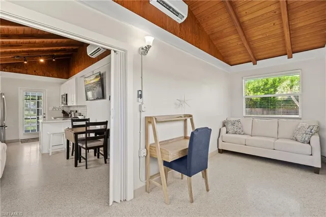 a living room with furniture and a dining table