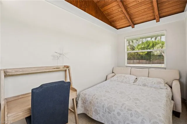 a bedroom with a bed and a window with the outer view