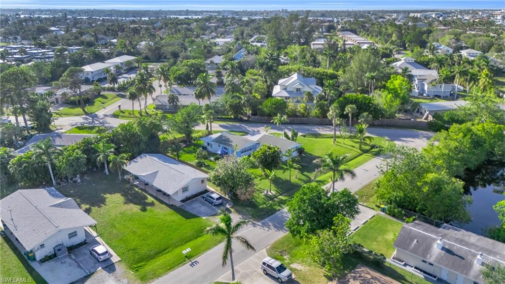 2134 Palm Street Naples, FL 34112 - Photo 33 of 36 an aerial view of residential houses with outdoor space and parking