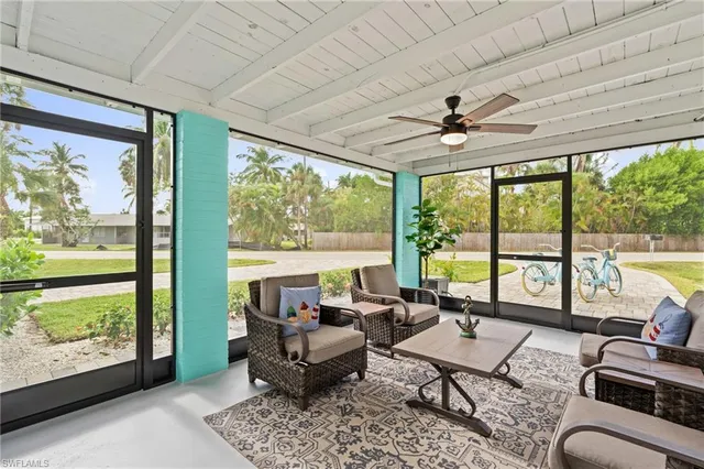 a living room with furniture and large windows