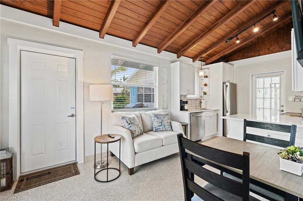 2134 Palm Street Naples, FL 34112 - Photo 6 of 36 a living room with furniture a table and kitchen view