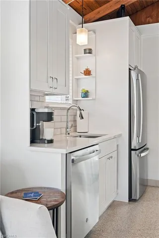 a kitchen with stainless steel appliances granite countertop a refrigerator and a sink