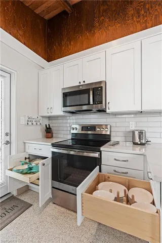 a kitchen with a sink a stove and cabinets