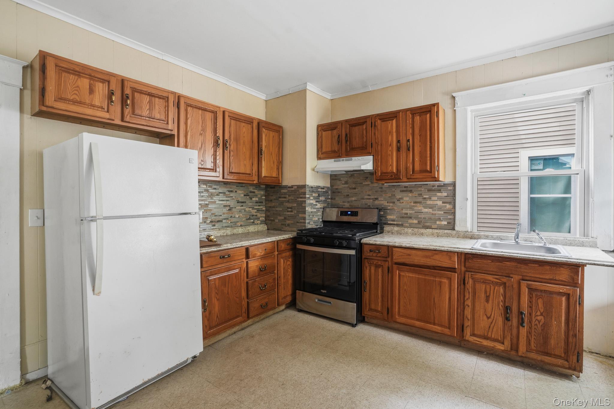65 North Clinton Street Poughkeepsie, NY 12601 - Photo 12 of 43 a kitchen with stainless steel appliances granite countertop a refrigerator and a sink