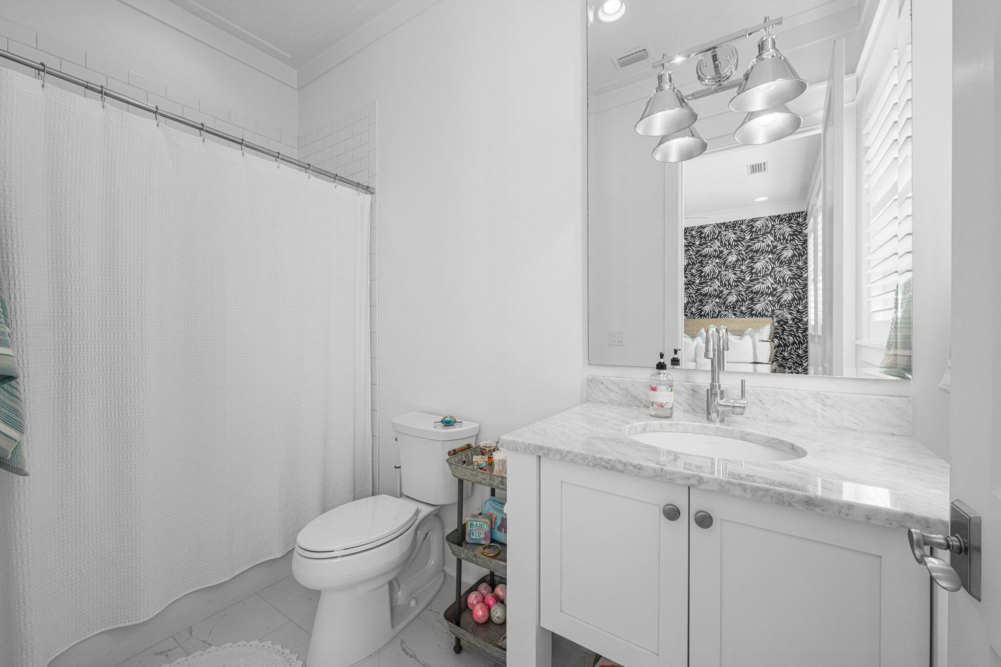 916 Pathways Dr Inlet Beach Inlet Beach, FL 32461 - Photo 31 of 48 a bathroom with a sink vanity mirror and toilet