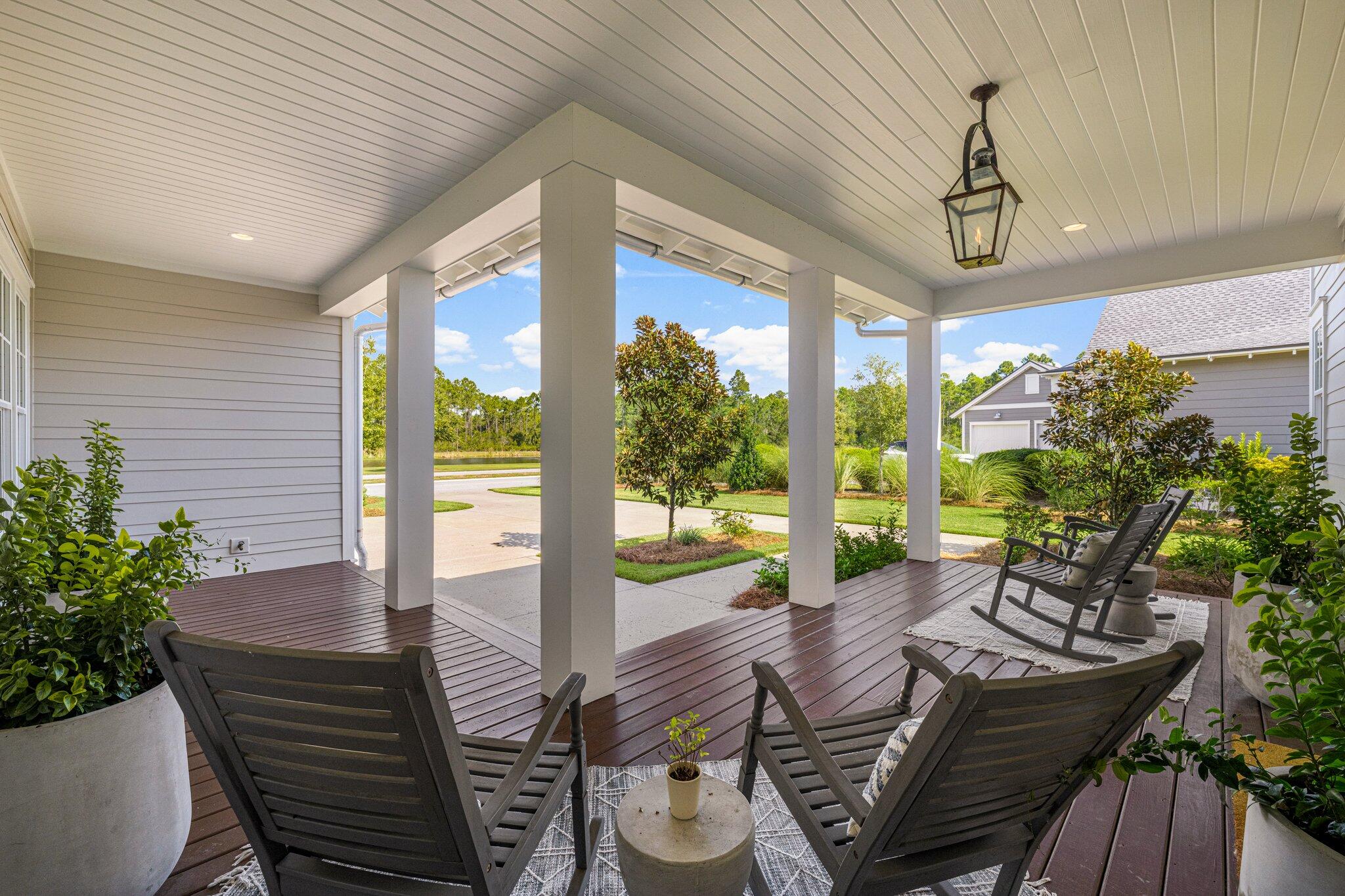 916 Pathways Dr Inlet Beach Inlet Beach, FL 32461 - Photo 5 of 48 a view of a patio with table and chairs potted plants with wooden floor