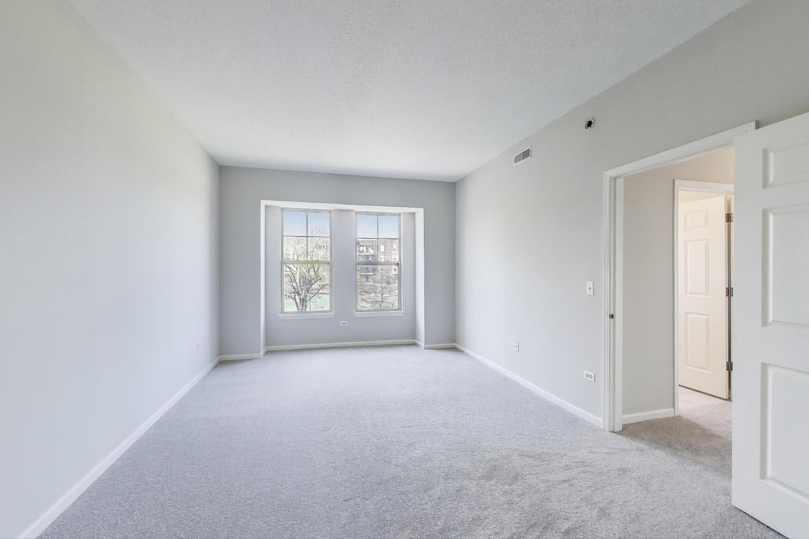 715 Astor Lane, Unit 307 Wheeling, IL 60090 - Photo 16 of 38 a view of an empty room with a window