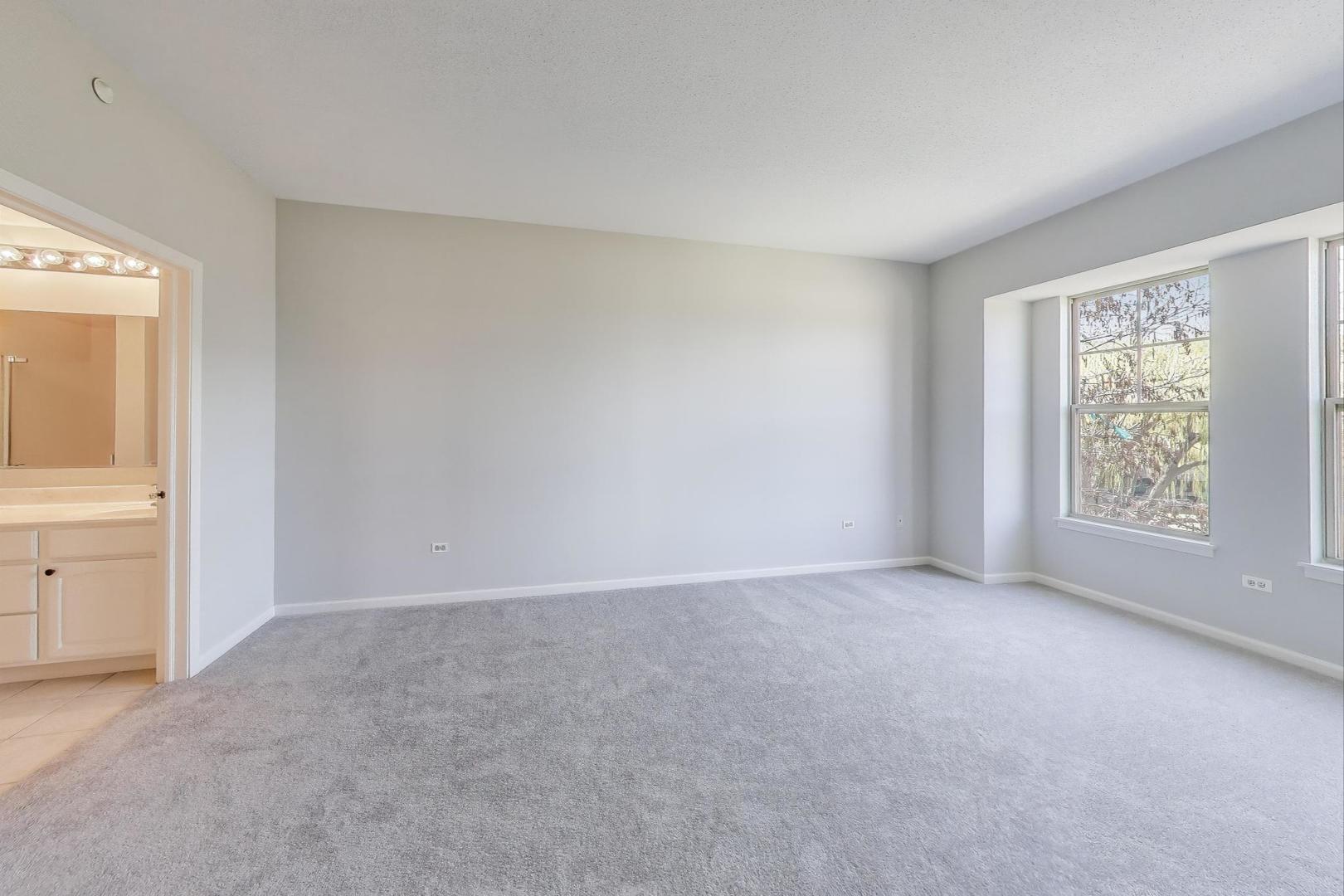 715 Astor Lane, Unit 307 Wheeling, IL 60090 - Photo 18 of 38 an empty room with windows