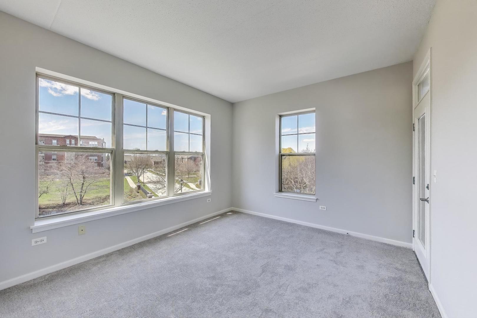 715 Astor Lane, Unit 307 Wheeling, IL 60090 - Photo 21 of 38 an empty room with windows