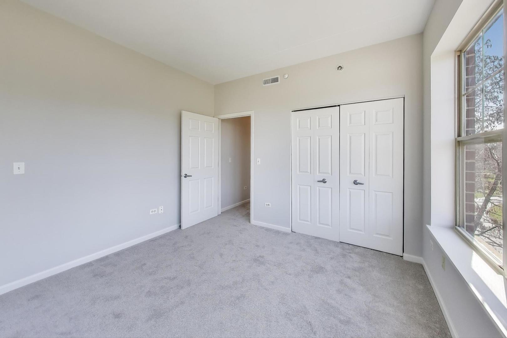 715 Astor Lane, Unit 307 Wheeling, IL 60090 - Photo 22 of 38 a view of an empty room with a window