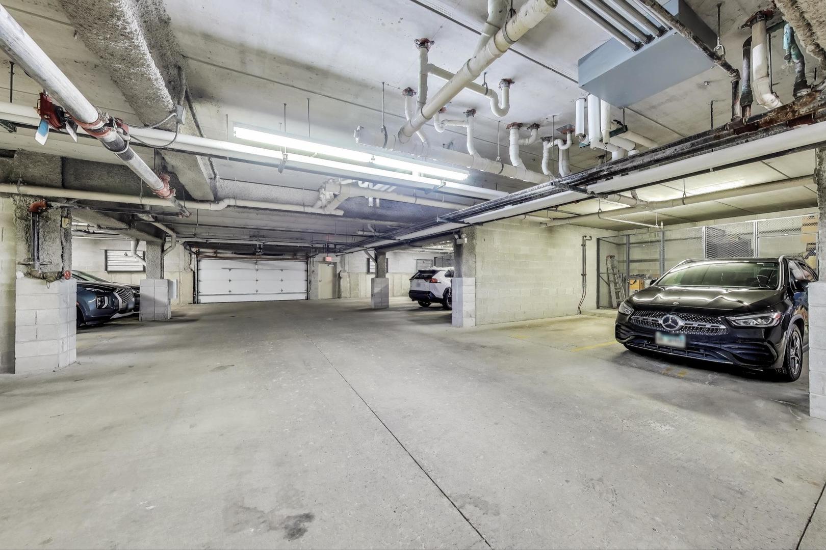 715 Astor Lane, Unit 307 Wheeling, IL 60090 - Photo 29 of 38 a view of parking garage with cars