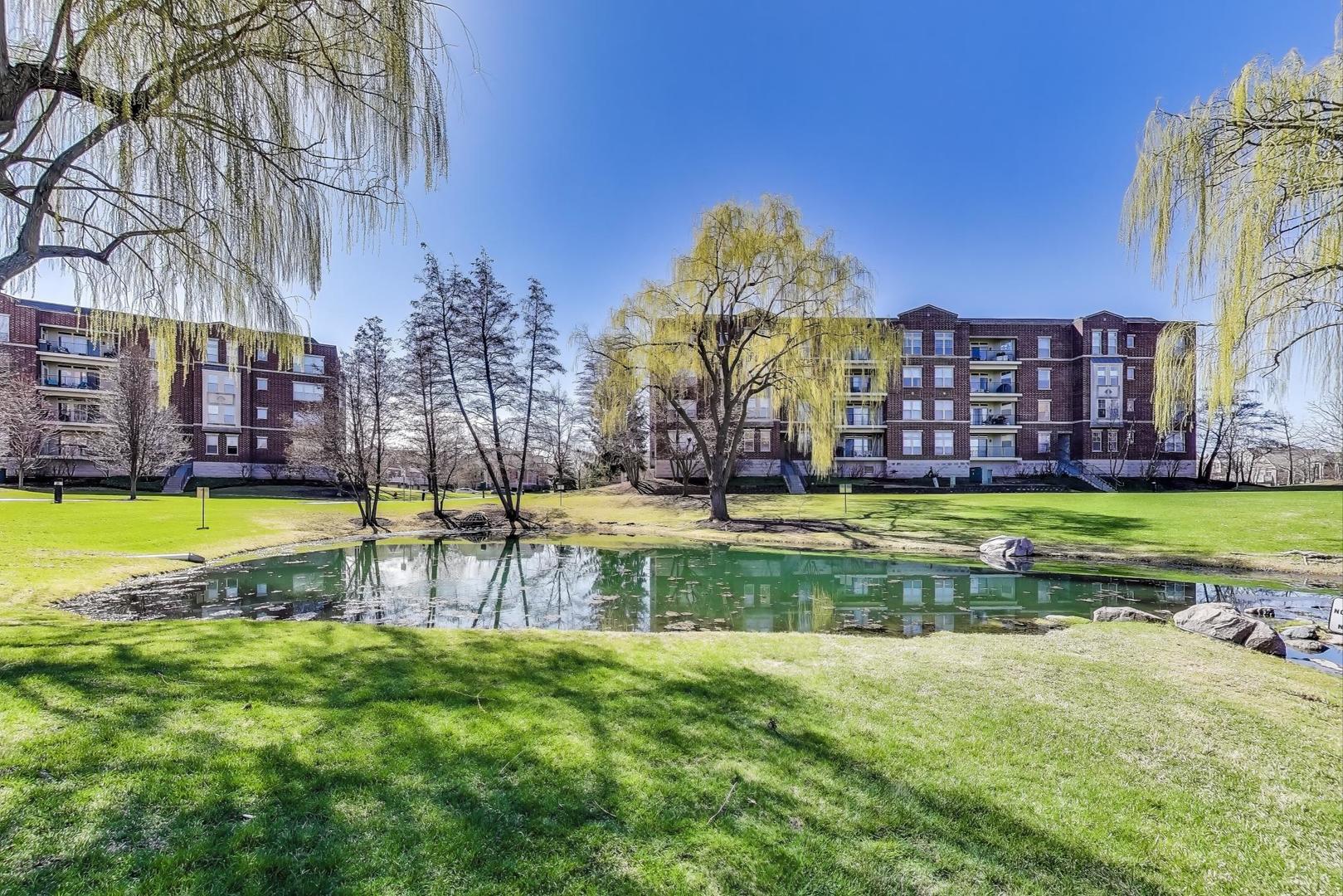 715 Astor Lane, Unit 307 Wheeling, IL 60090 - Photo 33 of 38 a view of a swimming pool with a building in the background