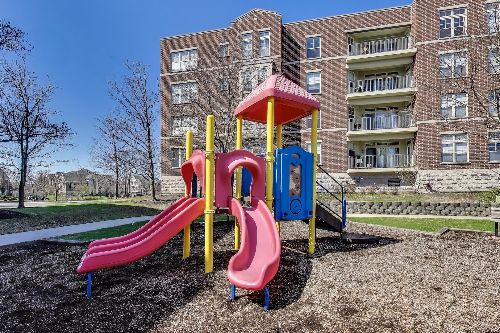 715 Astor Lane, Unit 307 Wheeling, IL 60090 - Photo 35 of 38 a view of a park with multi story buildings