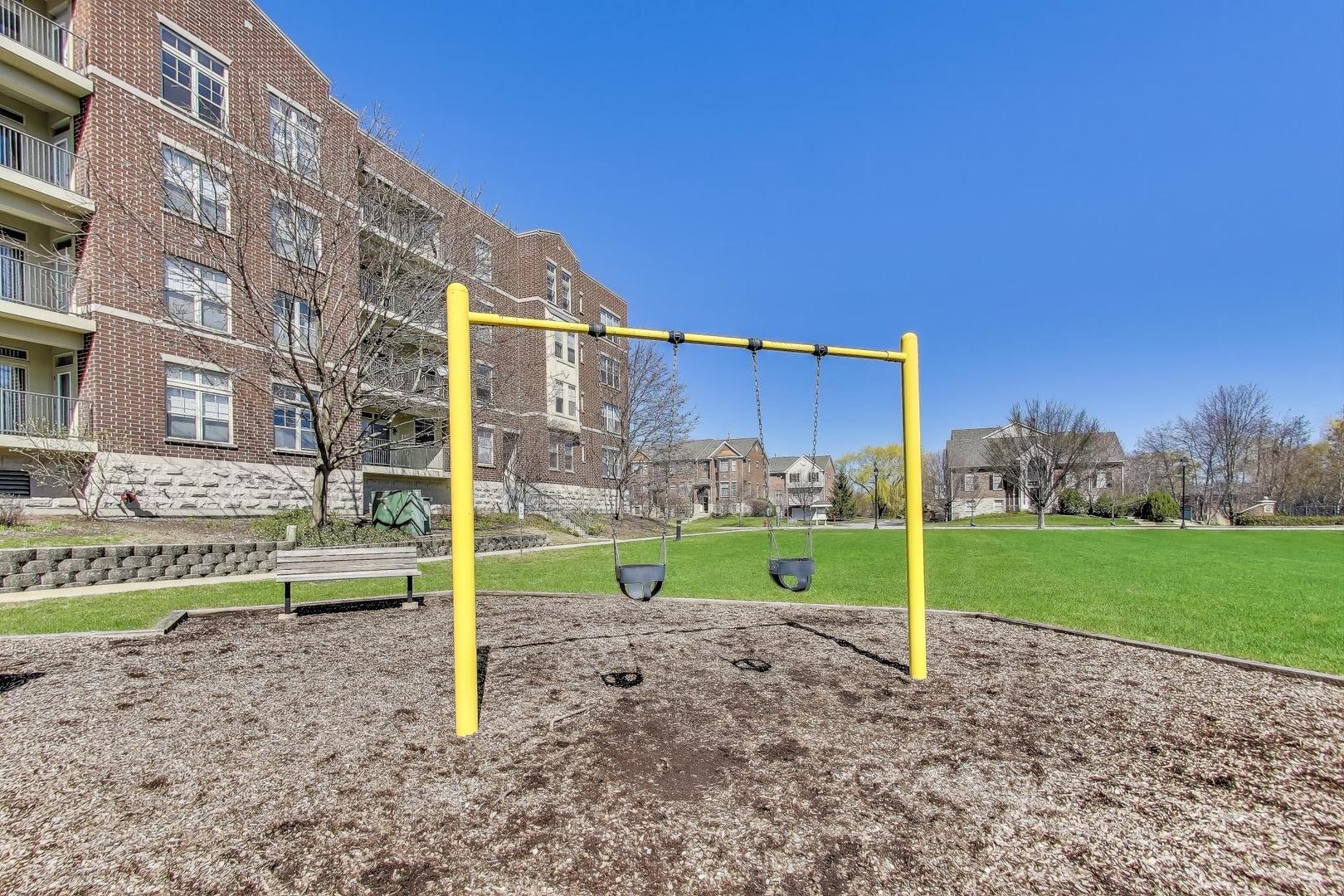 715 Astor Lane, Unit 307 Wheeling, IL 60090 - Photo 36 of 38 a view of a house with a yard and a table