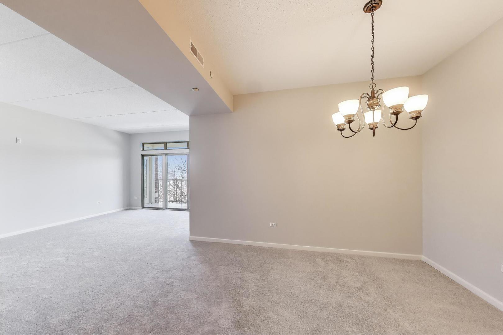 715 Astor Lane, Unit 307 Wheeling, IL 60090 - Photo 8 of 38 a view of a chandelier in big room and chandelier