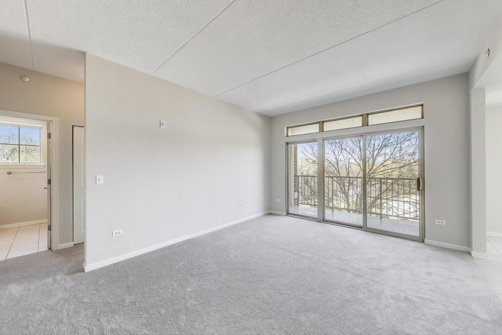 715 Astor Lane, Unit 307 Wheeling, IL 60090 - Photo 9 of 38 a view of an empty room with a window