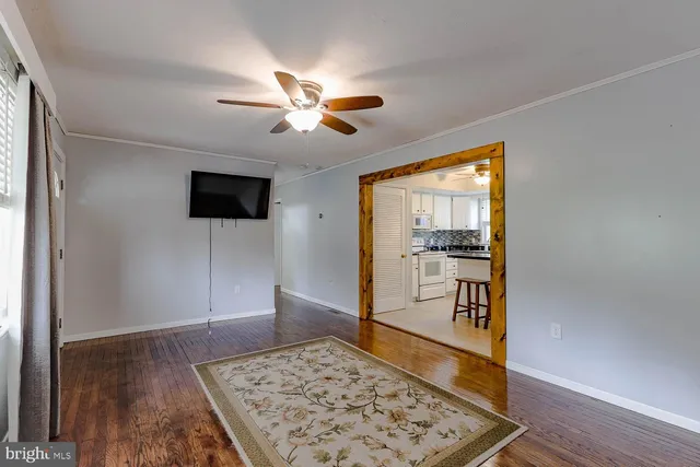 a living room with a flat screen tv and a rug