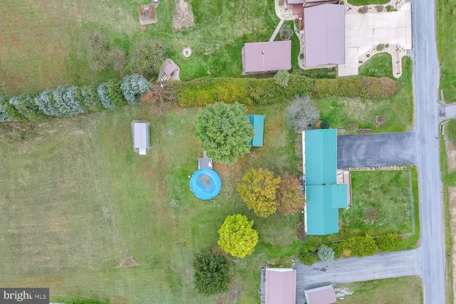 a aerial view of a house with yard swimming pool and outdoor seating
