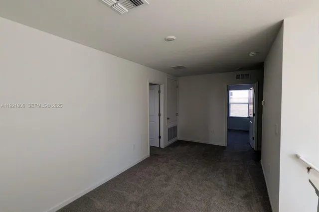 a view of a hallway with a room