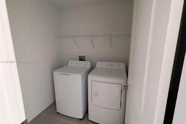 a front view of house with yard and trees around