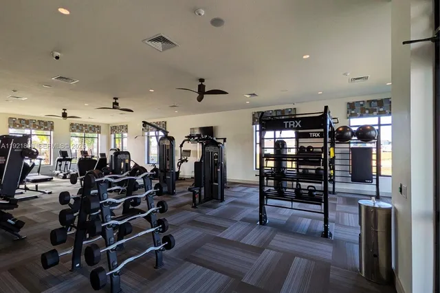 a view of a swimming pool with lawn chairs under an umbrella