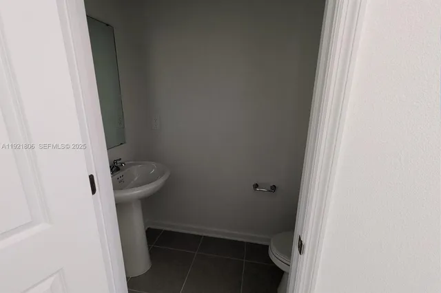 a view of a kitchen with a sink and dishwasher a stove top oven with wooden floor