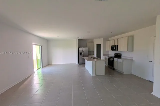 a view of a livingroom with furniture and a window
