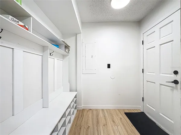 a view of hallway with wooden floor and stairs