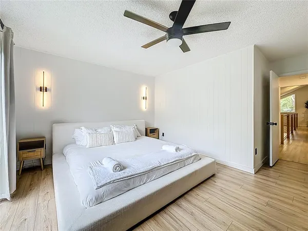 a bedroom with a large bed and a window