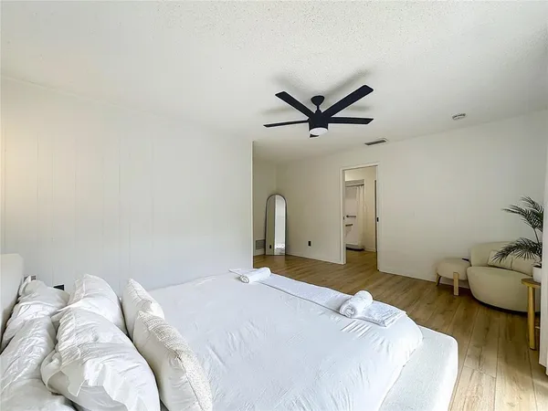 a bed sitting in a bedroom next to a window