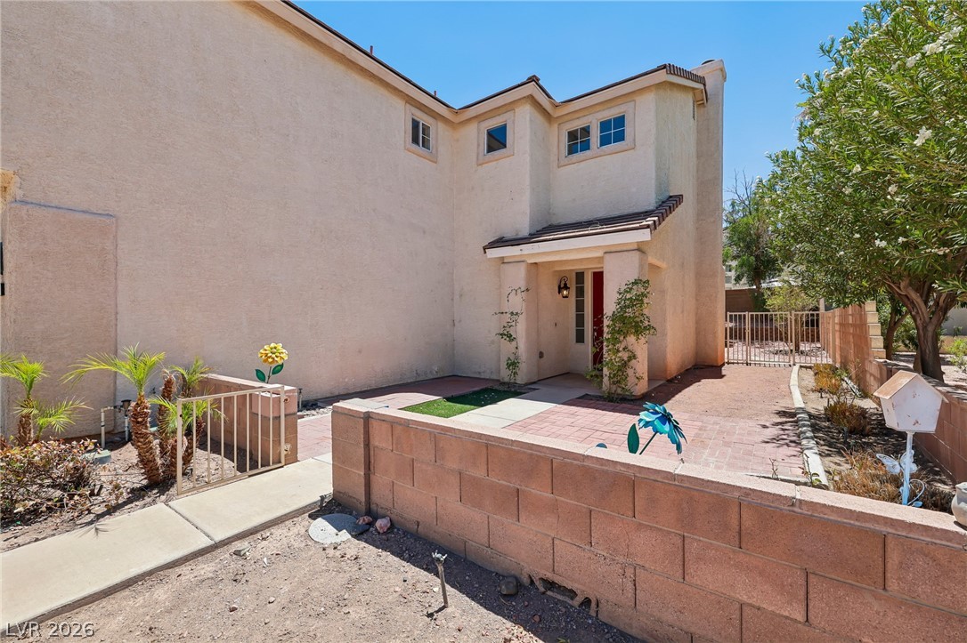 1727 Millstream Way Henderson, NV 89074 - Photo 8 of 46 A terracotta-hued exterior with a welcoming red front door awaits at this charming residence.
