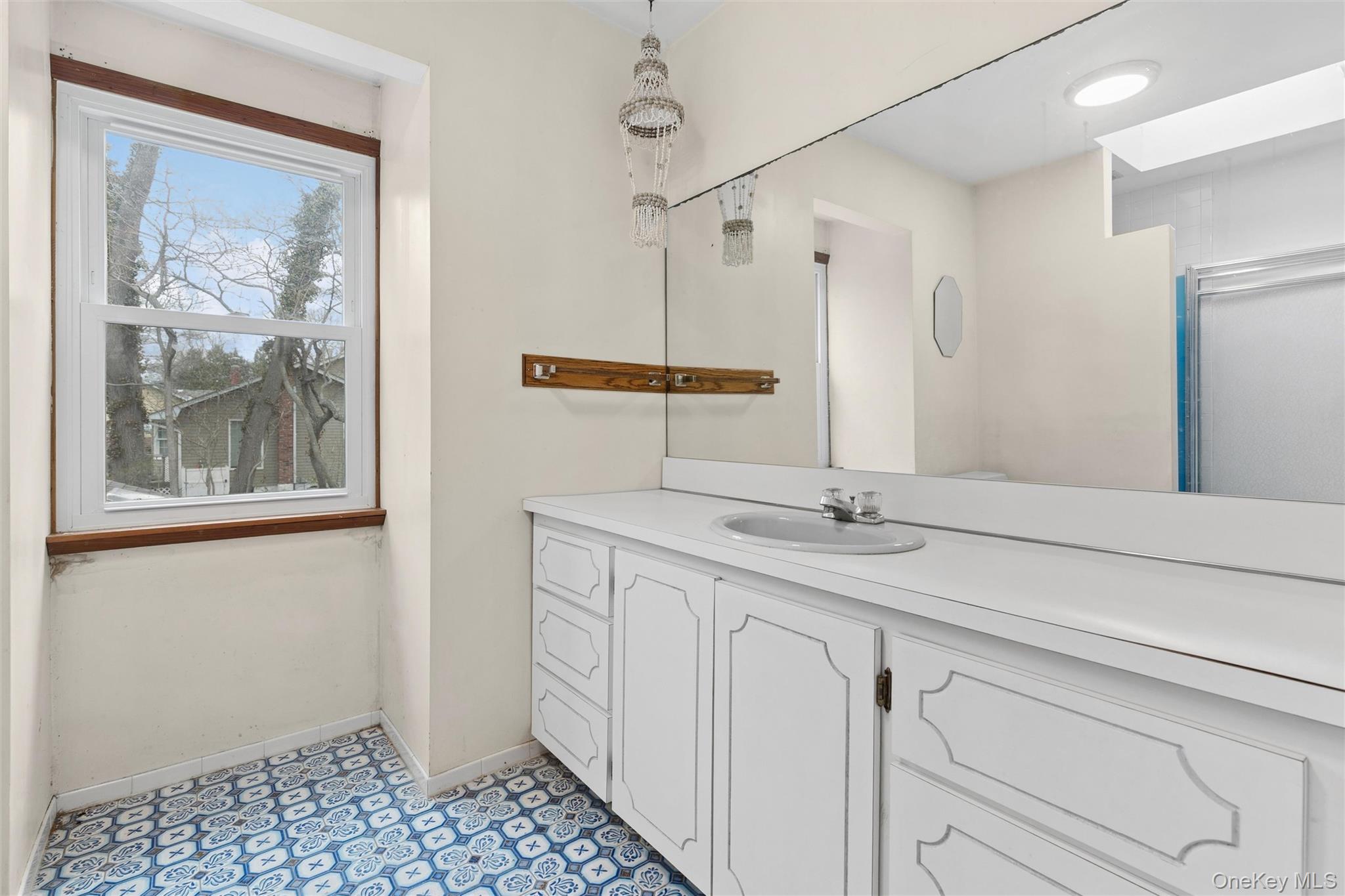 49 Overhill Road Wading River, NY 11792 - Photo 22 of 27 a bathroom with a sink and a mirror