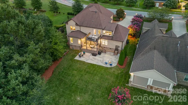 a view of a house with a big yard and large trees