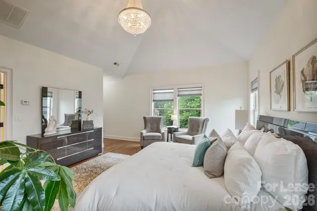 a living room with furniture and a painting on the wall